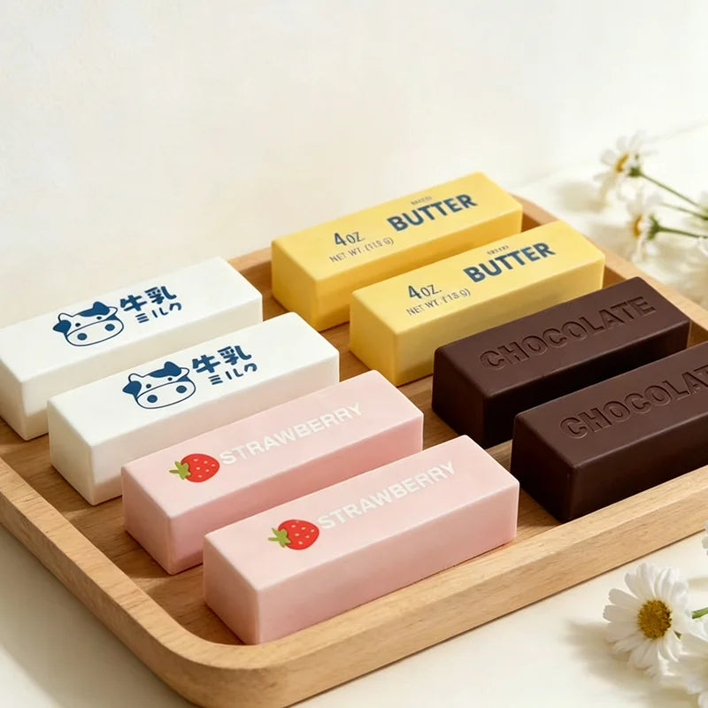 Mini butter stick and chocolate bar squishies laid out on a wooden tray