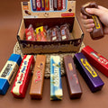 A box of chocolate bar and butter stick squishies with printed wrappers