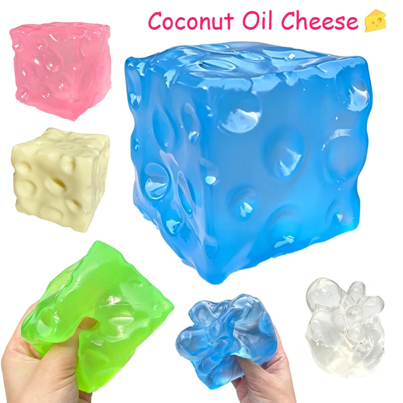 Translucent blue coconut oil cheese block squishy with moulded holes, shown with other colours