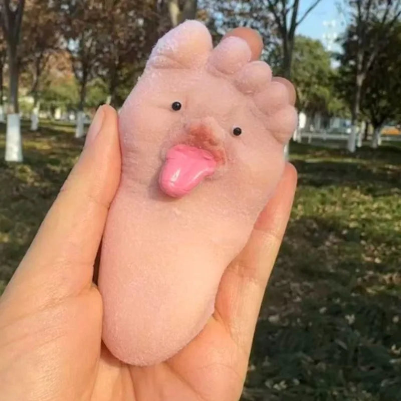 Soft silicone big foot squeeze toy sticking its tongue out when pressed