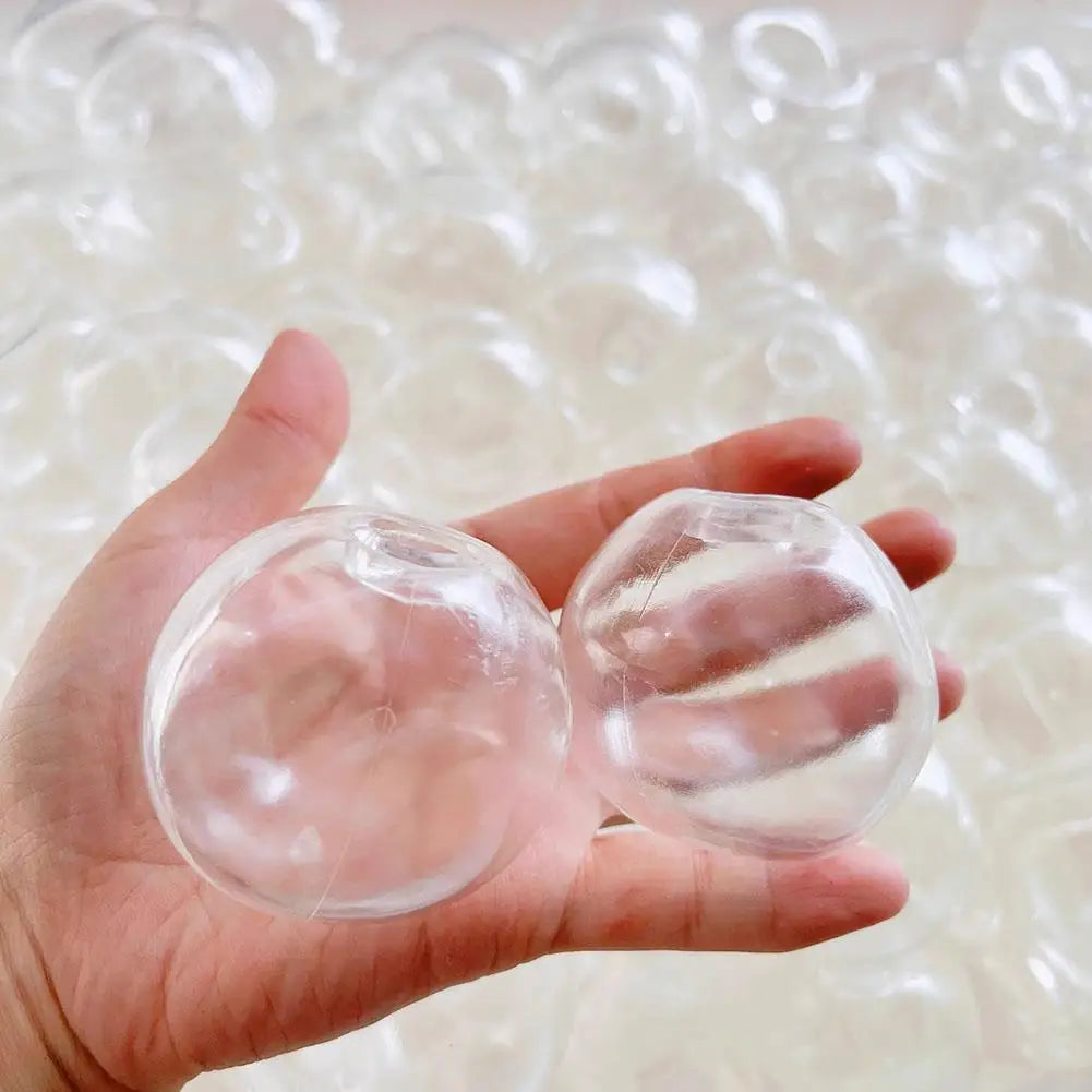 Two empty transparent DIY squishy ball skins held in a hand